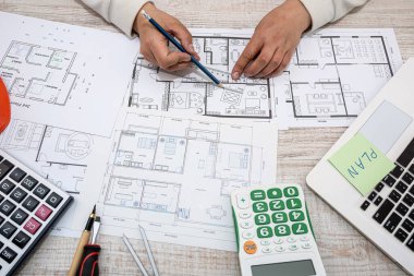 designer architect corrects his sketches of the plan of a new house outside the city. Design sketches concept