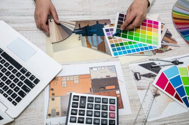 Art designer man chooses colors for office work. The choice of colors in the drawing of the apartment.