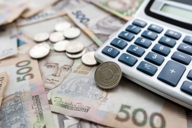 exchange of US dollars to Ukrainian hryvnias on the table with a calculator. Exchange rate concept