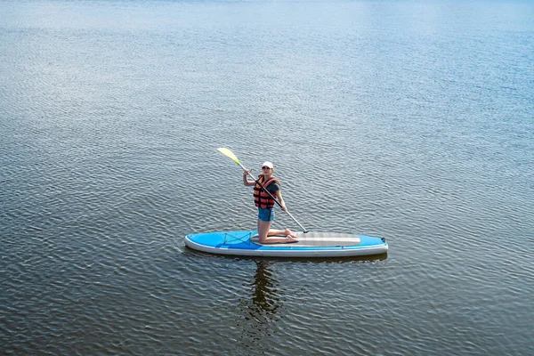 Όμορφη Αθλήτρια Ποζάρει Στο Νερό Του Σκάφους Και Πιάνει Τις — Φωτογραφία Αρχείου