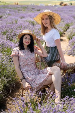 Happy and smiling friends in sunlight at lavender field