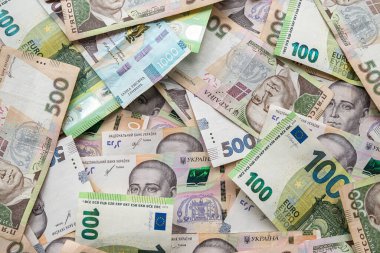top view close up of a complete set of hryvnia and euro banknotes. Currency concept