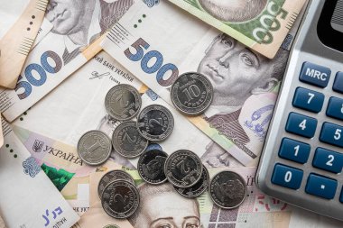 exchange of US dollars to Ukrainian hryvnias on the table with a calculator. Exchange rate concept
