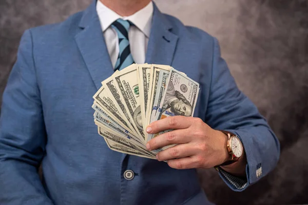 Young Business Serious Man Nicely Dressed Counts His Hands Dollars — Stok fotoğraf