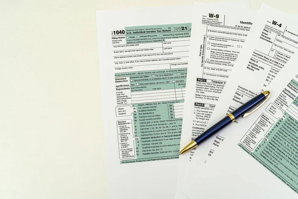 Tax Form 1040 per tax year for individual U.S. tax returns with a pen next to it. The concept of tax forms