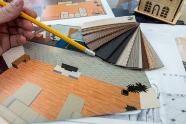 a young designer takes a project where you need to choose colors for a certain drawing of a new house. New building design concept