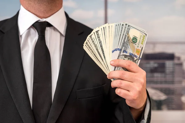 Rich man in formalwear businessman holding cash. Wealthy and confident man with dollar bills.