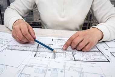 man throws sketches of drawings on paper with laptop. Designer makes sketches