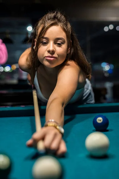 pretty caucasian woman playing snooker at pub. game concept