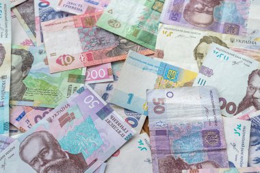 different UAH ukrainian money as background, finance concept, grivna