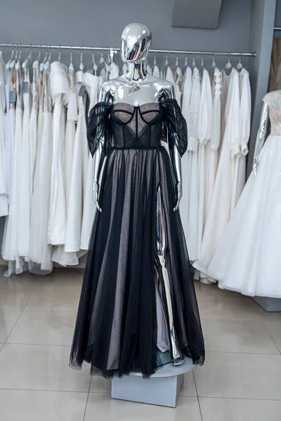 Elegant black evening dresses on the mannequin in showroom. Fashion concept