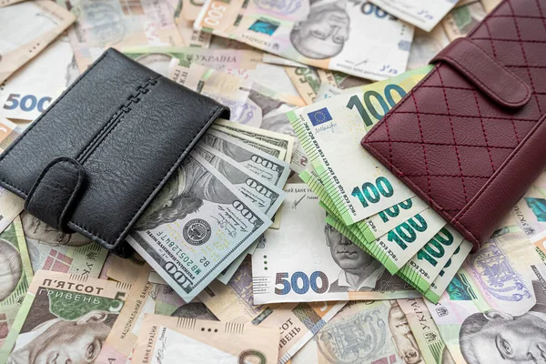 Money 100 dollars and  100 euros in wallet vs 500 1000 ukrainian hryvnia. exchange concept. UAH  