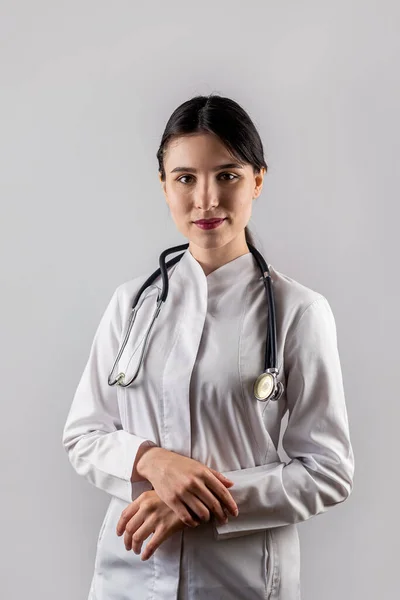 female doctor saves people's lives with a stethoscope and a sincere smile. woman concept on isolated plain background. Healthy Lifestyle. taking care of your health