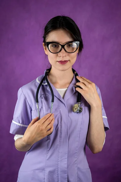 confident young woman doctor obstetrician smiles beautifully causing the trust of people of patients. portrait of a woman. isolated plain background. specialist obstetrician