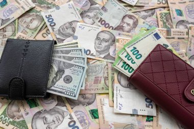 Money 100 dollars and  100 euros in wallet vs 500 1000 ukrainian hryvnia. exchange concept. UAH  