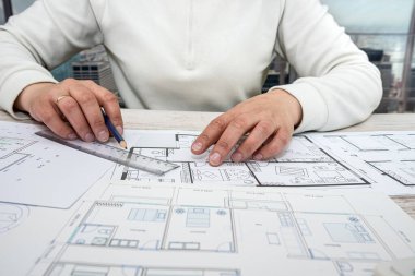 a man working on a drawing to create his home with professional design skills. Design concept