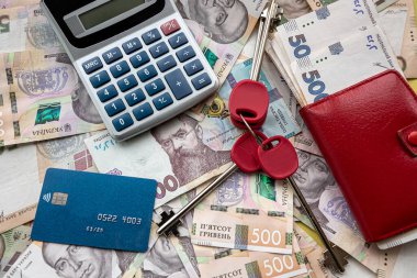 business concept sale or rent home ukraine money uah gryvnia calculator credit card and purse, saving concept
