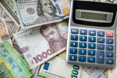 euro, dollars, hryvnia currency with calculator. Financial background. Money saving or exchange concept