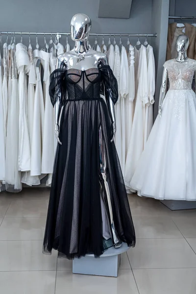 Elegant black evening dresses on the mannequin in showroom. Fashion concept