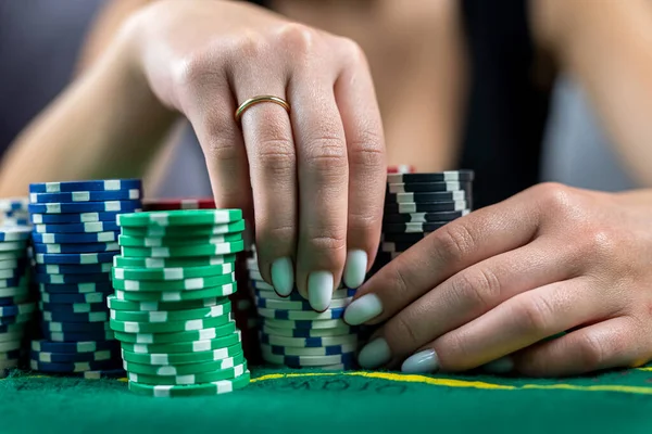 beautiful woman in evening black dress wins poker money in casino. Takes a bet on all chips. poker