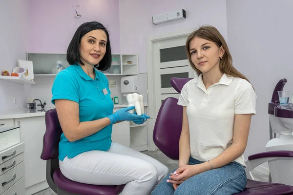 Dentist and patient choose treatment during consultation with medical equipment in beautiful clinic. a dentist patient at the dentist. consultation with the best dentist