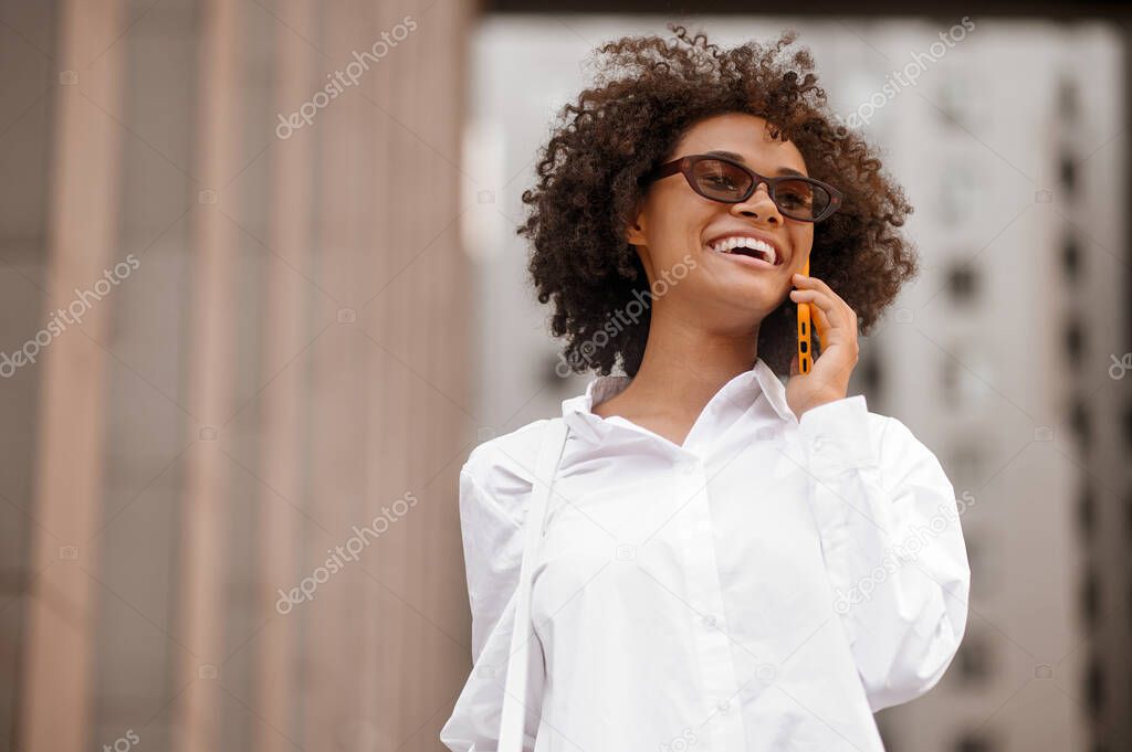 Young woman talking on the phone and looking excited