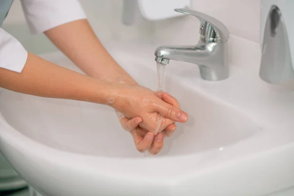 Close up picture of female hands being washed in a water basin — Stock Photo, Image