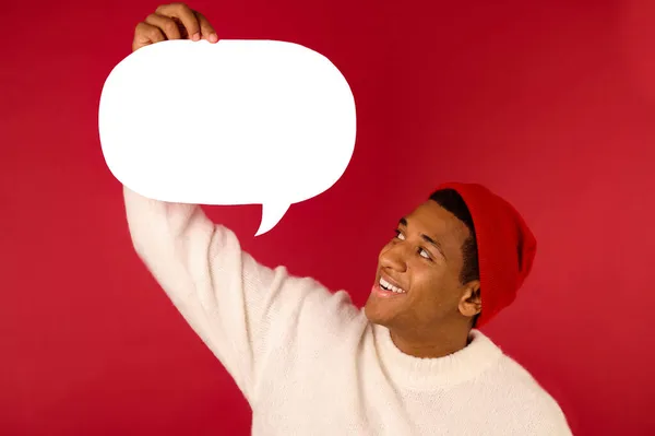 A young man in santa hat holding emoji — Stock Photo, Image