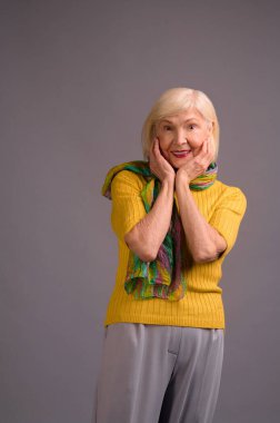 Cute woman in yellow shirt and with a green scarf