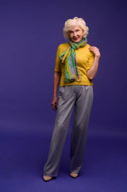 Wavy-haired senior woman in casual clothes an a green scarf