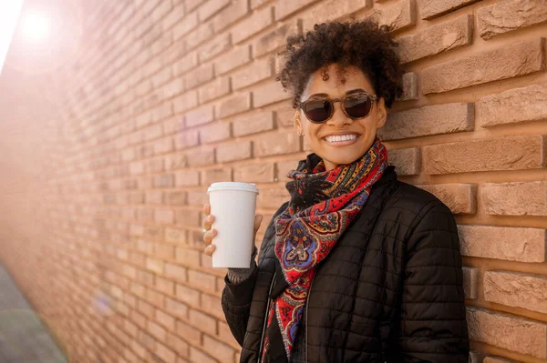 Roztomilá dívka ve slunečních brýlích s kávou venku — Stock fotografie