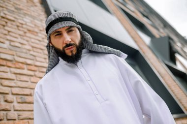 Arap adam. Geleneksel Arap kıyafetli adam ciddi görünüyor.