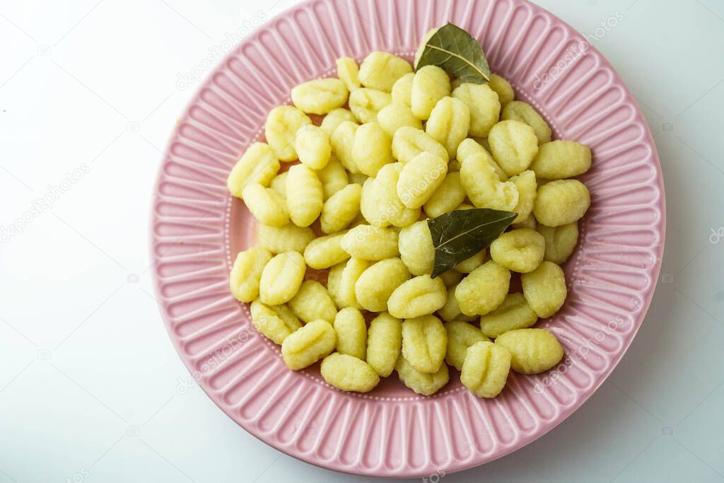 Plate of fresh gnocchi with olive oil and bay leaf