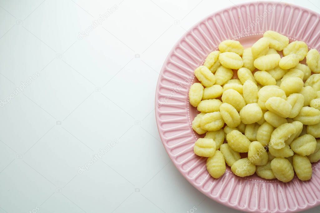 Plate of fresh gnocchi with olive oil and bay leaf