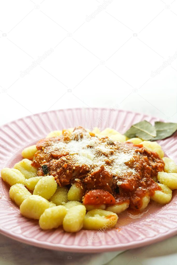Plate of fresh gnocchi with tomato sauce and grated Parmesan cheese