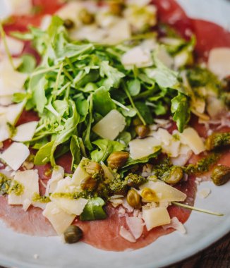 Arugula ve parmesanlı Carpaccio bifteği.