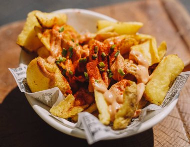 A portion of Spanish patatas bravas with spicy sauce