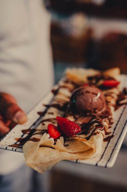 Dessert in a fancy restaurant, in the form of carrot cake, crepe and ice cream