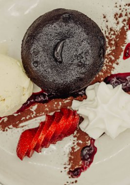 Dessert in a fancy restaurant, in the form of carrot cake, crepe and ice cream