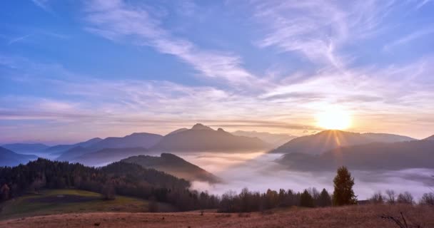 Fog moving in a valley in a mountain landscape at sunset. — Stock video