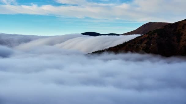 Cloud inversion, clouds spill over the mountain, waterfall from the clouds — Αρχείο Βίντεο