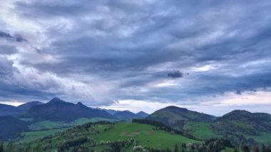 Spring landscape with cumulative clouds, A huge storm cloud forms over the mountains at dusk. 