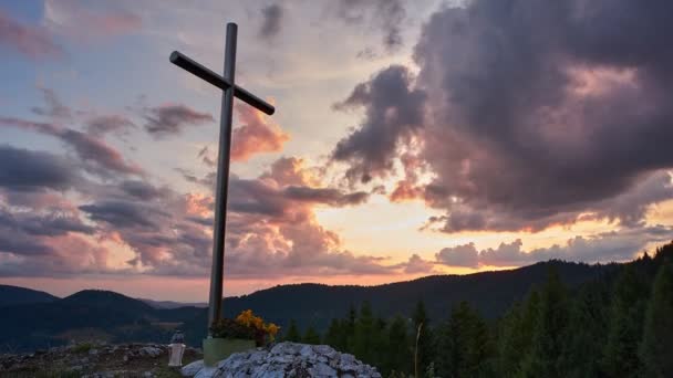 Christliches Kreuz auf einem Berggipfel bei Sonnenuntergang, religiöse Zeitraffer-Szene, 4K — Stockvideo