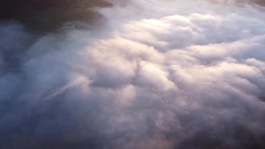 Aerial top view of inverse cloud cover in the light of the morning sun, Misty landscape. . High quality 4k footage