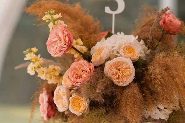 Boho wedding decor. Wedding centerpieces arrangements with dried flowers floristry and candles, boho style. Wedding day.