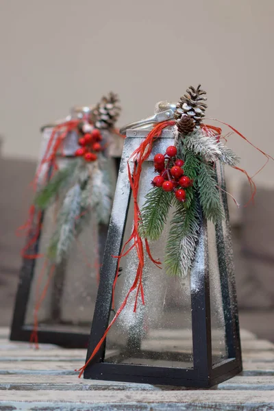 Lanterns decorated for Christmas with fir branches and red berries. — Stock Photo, Image