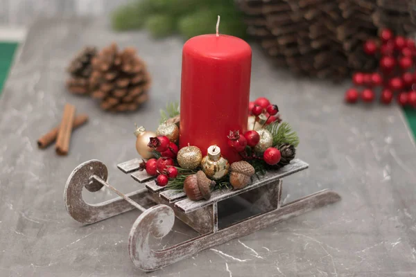 Christmas composition with candle in small sleigh. — Stock Photo, Image
