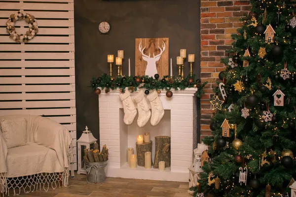 Cozy room with a Christmas atmosphere. Burning fireplace, glowing Christmas tree. Comfortable home environment with candles. Spirit of Christmas and New Year. Xmas. Loop video background.