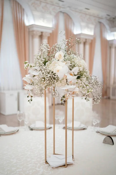 Wedding centerpieces, with metal vase and white fresh flowers arrangements. Wedding day. Wedding decor.