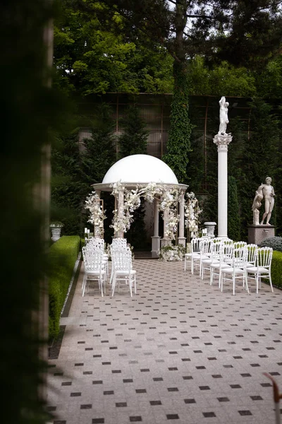 Wedding arch with white and pink roses. The arch is decorated with flowers. Wedding decor.